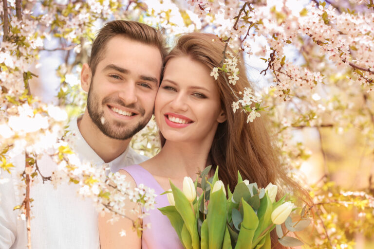 young lovely couple walking in spring park